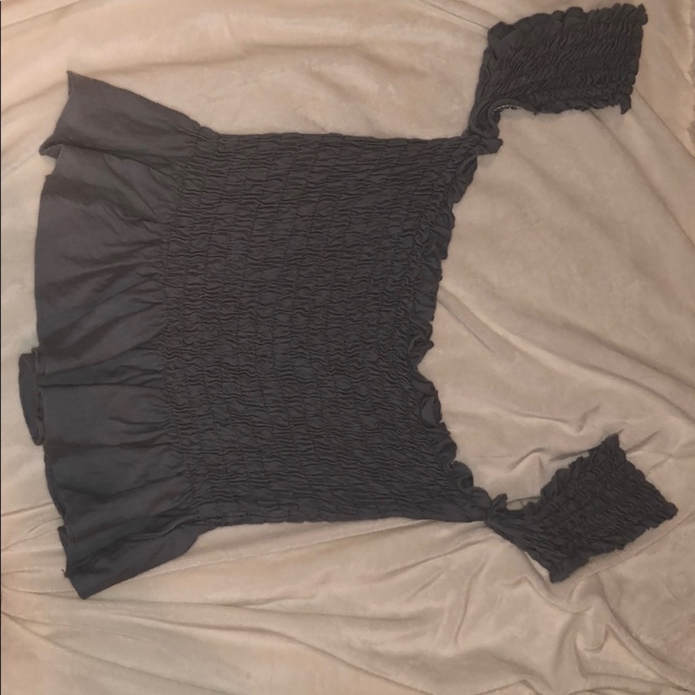 A blue off the shoulder shirt